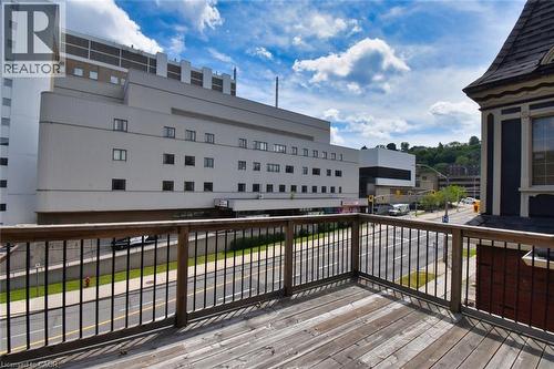 Outdoor deck featuring wood-finish flooring and a wood and metal railing system - 242 James Street S, Hamilton, ON 
