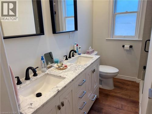 Double vanity with a stone countertop and matte black fixtures - 207 Charlton Avenue W, Hamilton, ON 