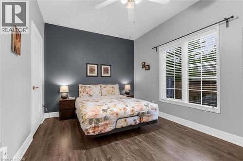 Room featuring wood-finish flooring, a vaulted ceiling with a ceiling fan, and a prominent accent wall - 149 Silverbirch Boulevard, Hamilton, ON 