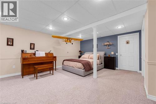 Carpeted room with recessed lighting, two-tone walls, and a white four-panel door - 149 Silverbirch Boulevard, Hamilton, ON 