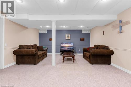 Spacious finished basement featuring recessed lighting, a neutral carpeted floor, and a contrasting accent wall - 149 Silverbirch Boulevard, Hamilton, ON 