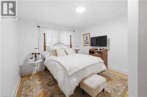 Well-lit room featuring light-toned wood-finish flooring, white walls, and a recessed ceiling light - 81 Vale Avenue, St. Catharines, ON 