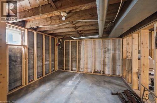 Unfinished basement space featuring exposed wood joists, concrete flooring, perimeter framing, and a visible window - 81 Vale Avenue, St. Catharines, ON 