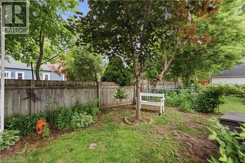 Fenced backyard featuring mature trees, a lawn area, and established plantings - 81 Vale Avenue, St. Catharines, ON 