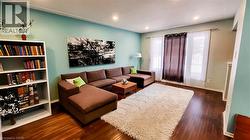 Spacious room featuring wood-finish flooring, recessed lighting, and multiple windows - 