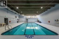 Indoor aquatic facility featuring a rectangular pool with lap lanes and a tiled edge - 