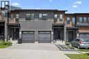 Modern townhome exterior featuring brick and wood-finish siding with black trim - 907 Robert Ferrie Drive, Kitchener, ON 