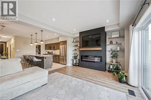 Open-concept living area with wood-finish flooring - 907 Robert Ferrie Drive, Kitchener, ON 