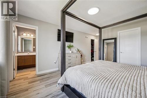 Light wood-finish flooring with a neutral wall color and ceiling-mounted light fixtures - 907 Robert Ferrie Drive, Kitchener, ON 