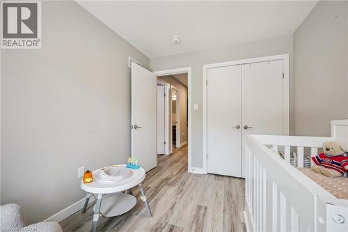 Light gray wall paint complemented by wood-finish flooring - 907 Robert Ferrie Drive, Kitchener, ON 