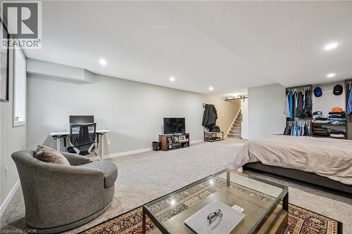 Spacious room with recessed lighting, light gray wall paint, and gray carpeting - 907 Robert Ferrie Drive, Kitchener, ON 
