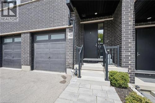 Modern facade featuring dark brickwork and black accents - 907 Robert Ferrie Drive, Kitchener, ON 