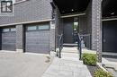 Modern facade featuring dark brickwork and black accents - 907 Robert Ferrie Drive, Kitchener, ON 