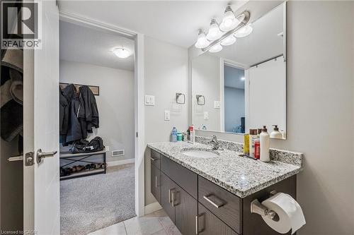 Bathroom featuring a vanity with granite countertop and integrated sink - 907 Robert Ferrie Drive, Kitchener, ON 