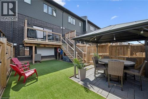 Private backyard featuring artificial turf and a paved patio area - 907 Robert Ferrie Drive, Kitchener, ON 