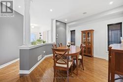 Elegant Dining Area Features Hardwood Flooring - 