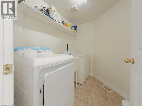 Utility room with tiled flooring and white walls - 78 Colton Circle, Kitchener, ON 