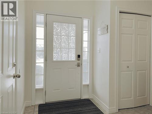 Entryway featuring a white paneled door with decorative frosted glass, sidelight windows, and a digital lock - 78 Colton Circle, Kitchener, ON 