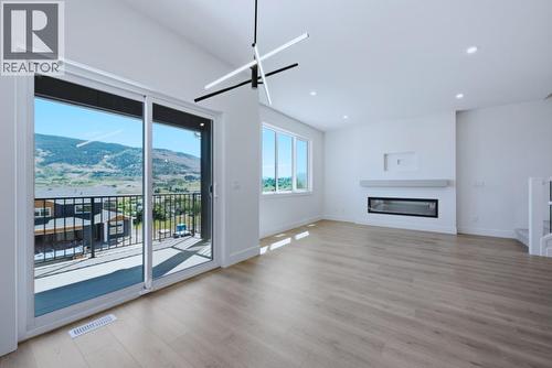 377 Arrowleaf Rise, Coldstream, BC - Indoor Photo Showing Living Room With Fireplace