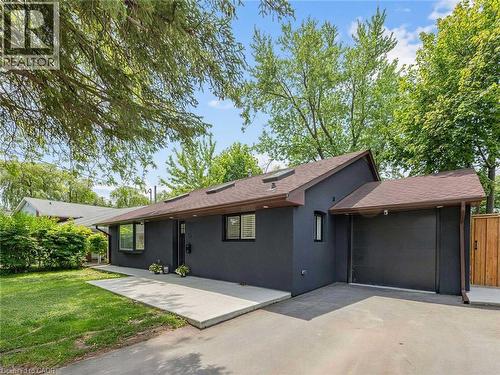 Contemporary exterior featuring dark gray siding and a brown shingle roof - 13 Swanhurst Boulevard, Mississauga, ON 