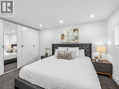 King sized bedroom with recessed lighting illuminates this space featuring wall-to-wall built-in cabinetry with full-length mirrored panels - 13 Swanhurst Boulevard, Mississauga, ON - Indoor Photo Showing Bedroom