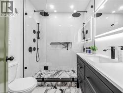 3 piece Ensuite bathroom- Walk-in shower with dual rain shower heads, matte black fixtures, and a recessed niche - 
