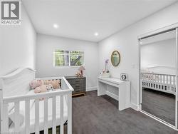 Room featuring recessed lighting, a window with horizontal blinds, gray patterned carpeting, and a mirrored closet door - 