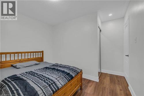 Bedroom featuring wood-finish flooring, recessed lighting, and a white interior door - 191 Stirling Macgregor Drive, Cambridge, ON 