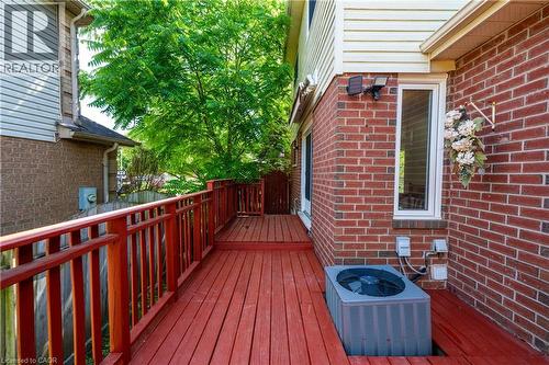 Red-stained wooden deck featuring matching railings and a privacy gate - 191 Stirling Macgregor Drive, Cambridge, ON 