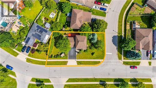 Aerial perspective showcasing a corner lot property with mature trees, a driveway, and surrounding streets - 191 Stirling Macgregor Drive, Cambridge, ON 