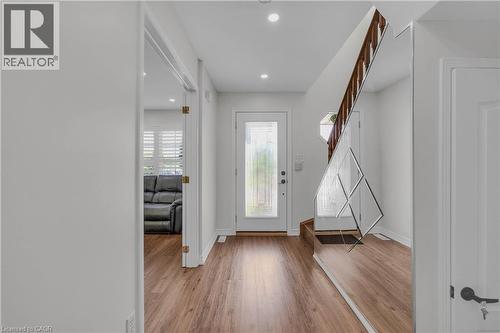 Entryway featuring wood-finish flooring, recessed lighting, and a white paneled door - 191 Stirling Macgregor Drive, Cambridge, ON 