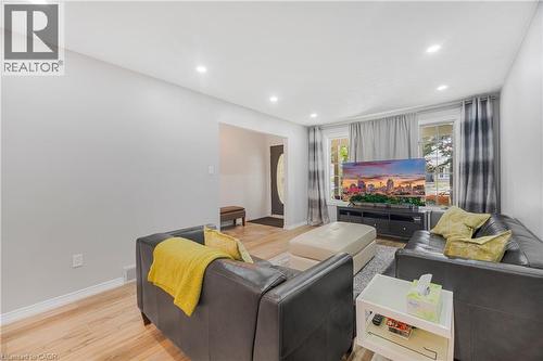 Bright living area featuring light-toned walls, recessed lighting, and wood-finish flooring - 23 Millpond Place, Mountain, ON 