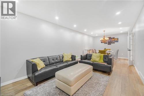 Spacious living area featuring light wood-finish flooring, recessed lighting, and a neutral wall palette - 23 Millpond Place, Mountain, ON 