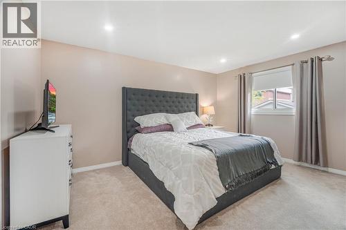 Carpeted room featuring recessed lighting, a neutral wall color, and a window with roller blind and drapery - 23 Millpond Place, Mountain, ON 
