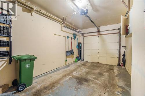 Single-car garage with a paneled garage door and an automatic opener - 23 Millpond Place, Mountain, ON 