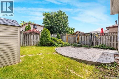 Private backyard featuring a stamped concrete patio - 23 Millpond Place, Mountain, ON 