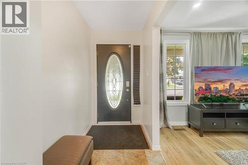 Entryway featuring a decorative oval glass insert door, neutral wall tones, and tiled flooring - 23 Millpond Place, Mountain, ON 