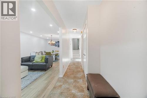 Hallway featuring ceramic tile flooring and white bifold doors - 23 Millpond Place, Mountain, ON 