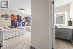 Carpeted room with a built-in bed frame featuring storage drawers - 