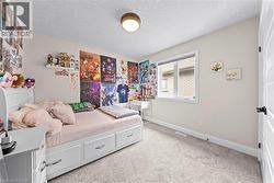 Carpeted room with a double-pane window, flush-mount ceiling light, white baseboards, and a white interior door with black hardware - 