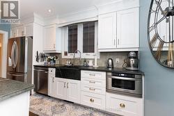 Galley kitchen with sandstone countertops. - 