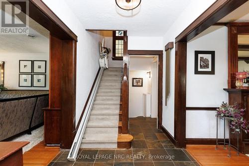 Wooden staircase with chair lift. - 52 Yates Street, St. Catharines (Downtown), ON 