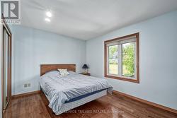spacious main floor bedroom with hardwood floors - 