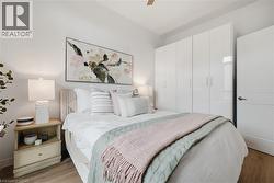 Bright bedroom with wood-finish flooring - 