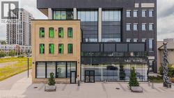 Mixed-use architectural design featuring a brick-clad three-story structure integrated with a modern glass and dark-paneled building - 