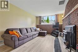 Living area featuring light wood-finish flooring and neutral wall tones - 