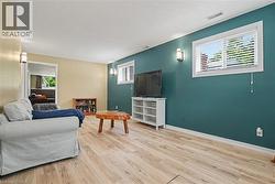 Open concept living area with wood-finish flooring - 