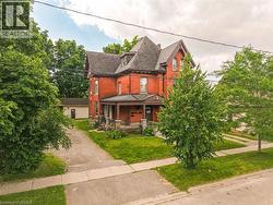 Brick exterior with a prominent gabled roofline and multiple window styles - 