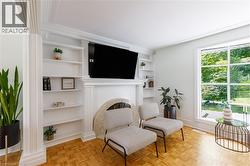 Built-in shelving flanking a central fireplace with an arched stone surround - 