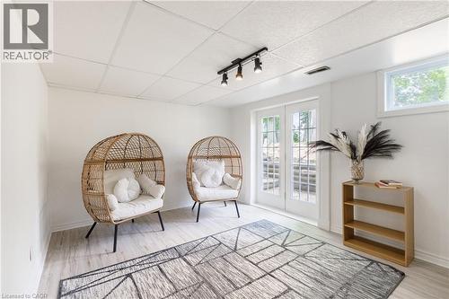 Lower level space featuring light wood-finish flooring, white walls, and a drop ceiling with recessed lighting - 176 Riverbank Drive, Cambridge, ON 
